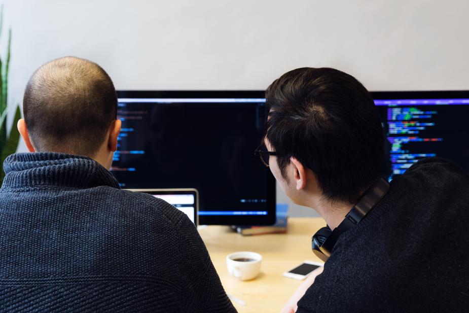 Two guys working at computers