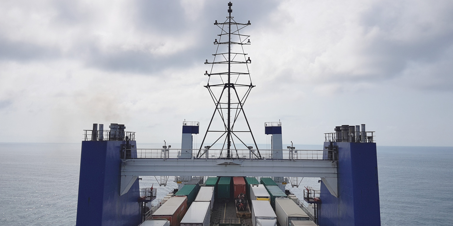 Cargo ship on sea with dark clouds