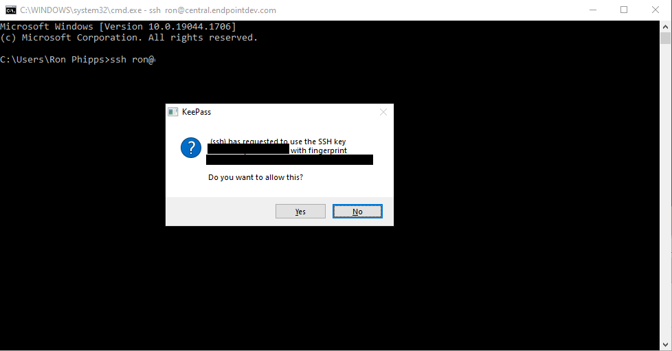 Windows Command Prompt running SSH, with the same KeePass dialog box asking approval for using the loaded SSH key