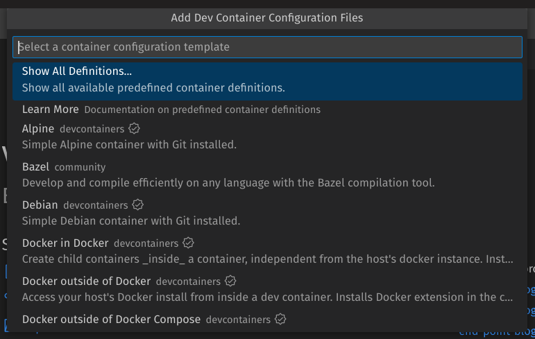 A pop-up reading “Add Dev Container Configuration Files. The cursor is in a search box reading “Select a container configuration template”. Selected is the option reading “Show All Definitions…